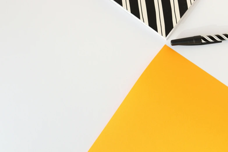 a black and white striped tie sitting on top of a yellow piece of paper, an abstract drawing, trending on unsplash, de stijl, clean white paper background, black and orange colour palette, yellow parasol, 4 k detail