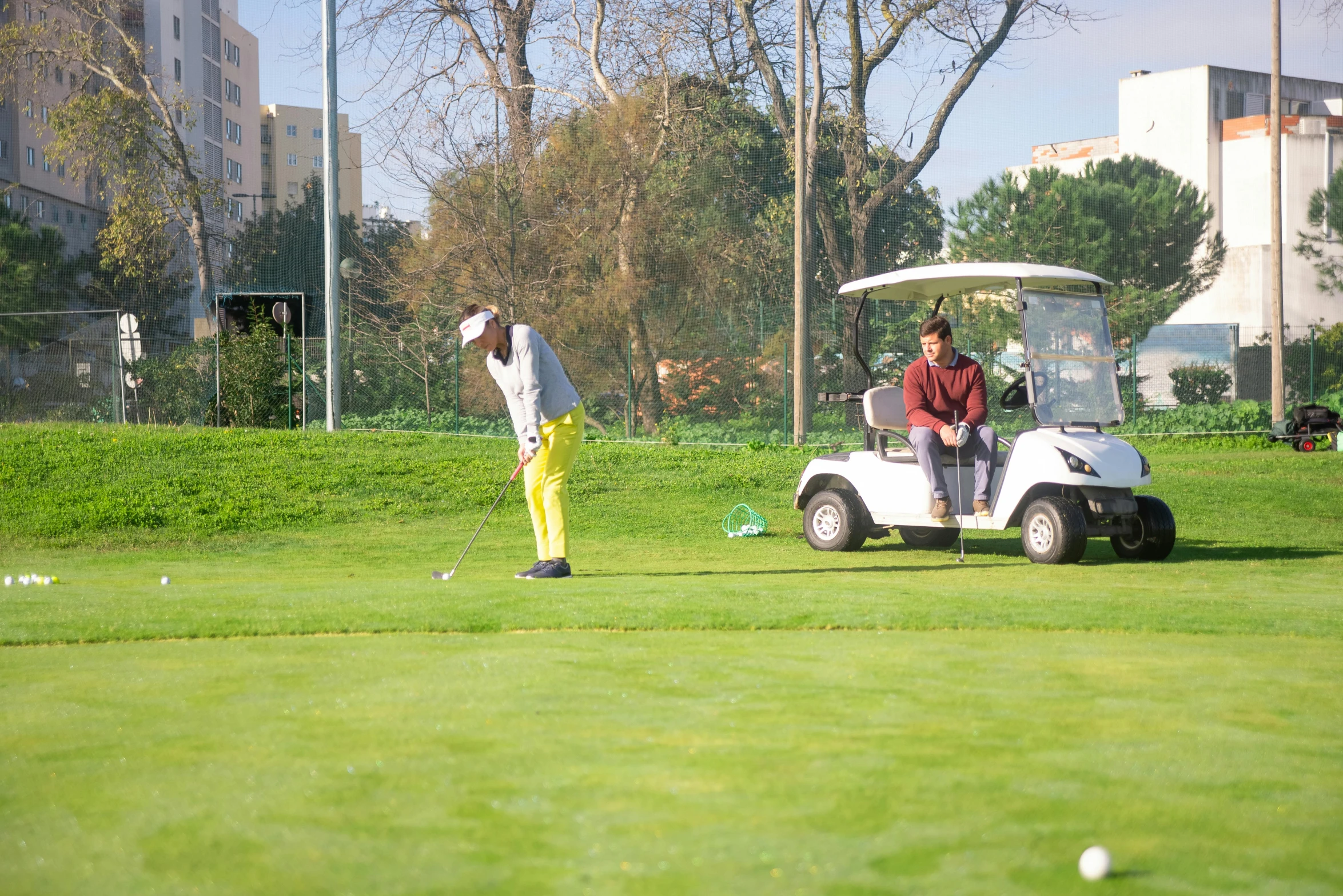 a man riding a golf cart on top of a green field, ahmad merheb, city park, avatar image