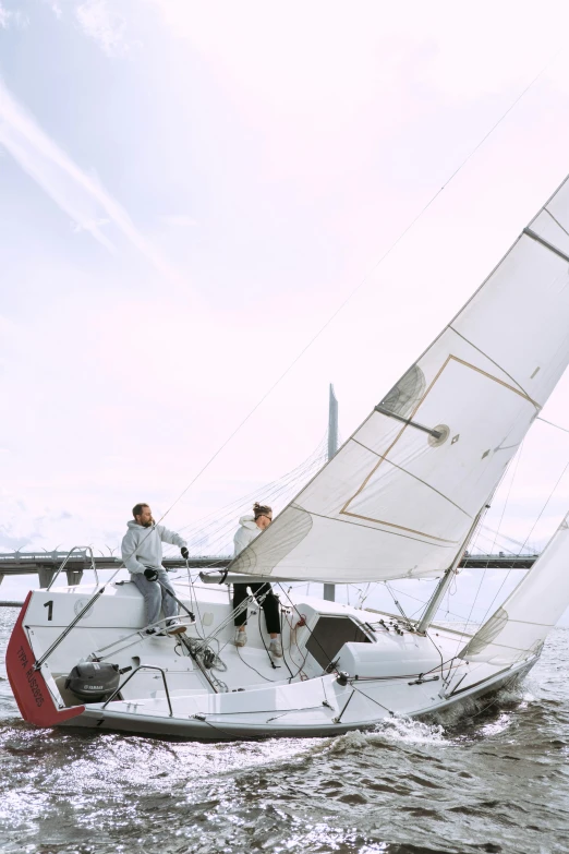 a couple of people on a sailboat in the water, helsinki, aerodynamic, very elegant & complex, grey