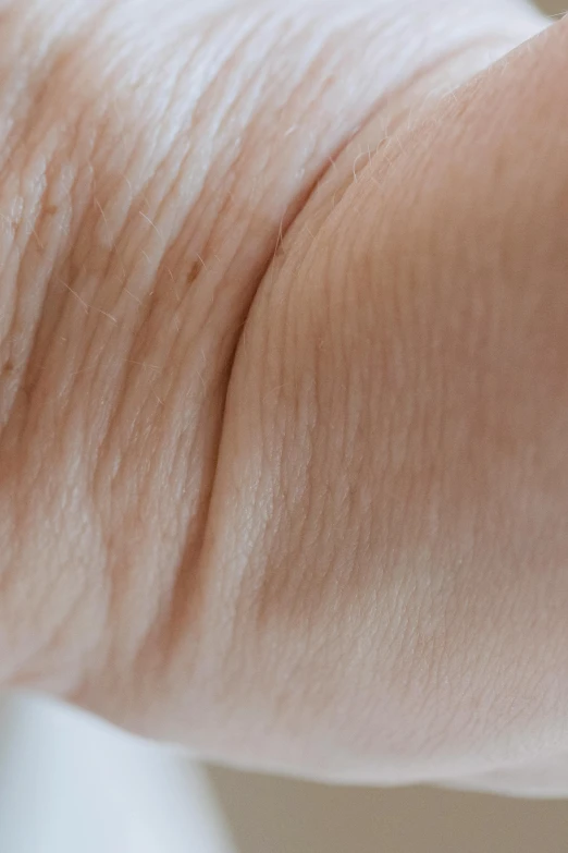 a close up of a person's hand holding a toothbrush, wrinkled muscles skin, black fine lines on warm brown, bald lines, sinuous fine roots