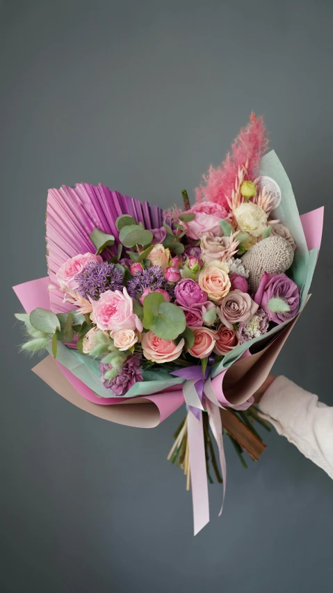 a close up of a person holding a bunch of flowers, a pastel, inspired by François Boquet, vibrant pink, wrapped, award - winning, cupid