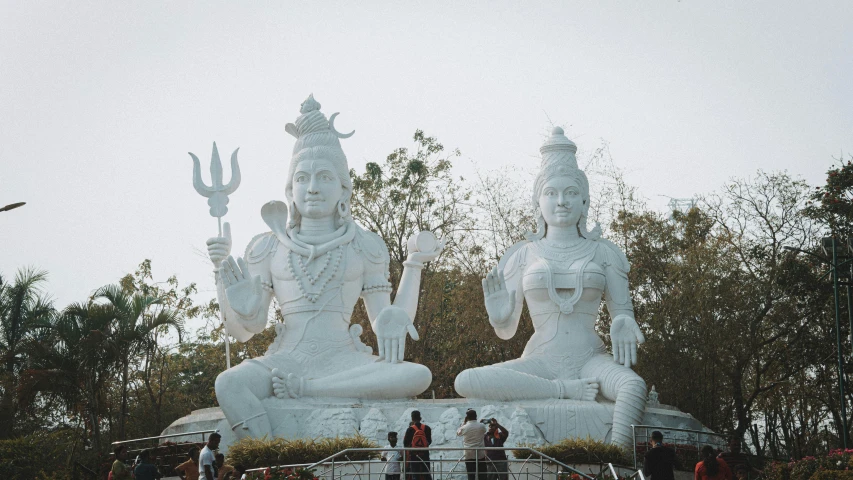 a group of white statues sitting on top of a lush green field, a statue, pexels contest winner, samikshavad, lord shiva, medium shot of two characters, 🦩🪐🐞👩🏻🦳, black