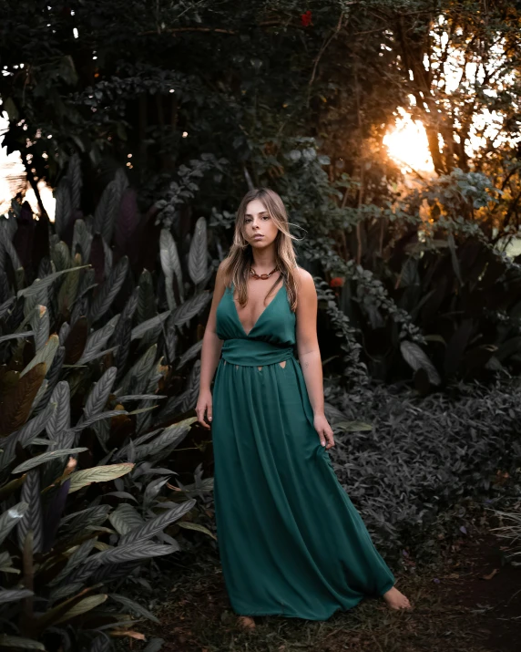 a woman in a green dress posing for a picture, an album cover, inspired by Elsa Bleda, pexels contest winner, lush surroundings, sun down, 5 0 0 px models, ( ( ( kauai ) ) )