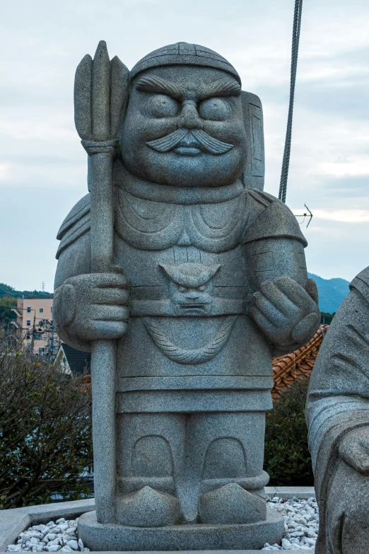 a couple of statues sitting next to each other, a statue, inspired by Takeuchi Seihō, sōsaku hanga, closeup of arms, man holding spear, front face symmetrical, nagasaki