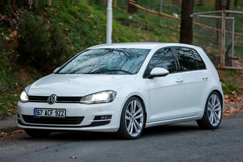 a white volkswagen golf parked on the side of the road, a picture, high-quality dslr photo”, michal mraz