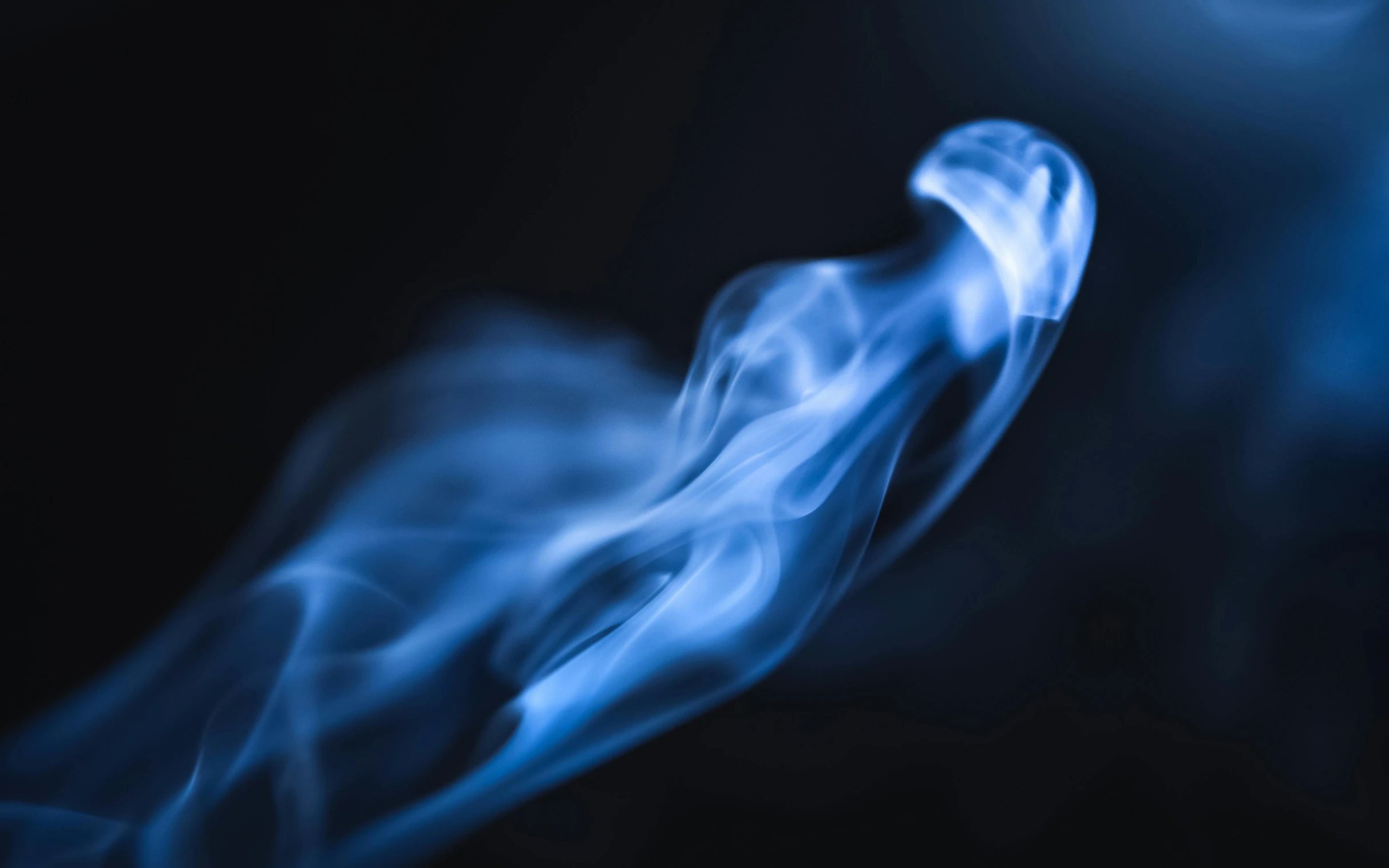 a close up of smoke on a black background, by Daniel Lieske, unsplash, on blue fire, ghostly ghost, a friendly wisp, blue blurred