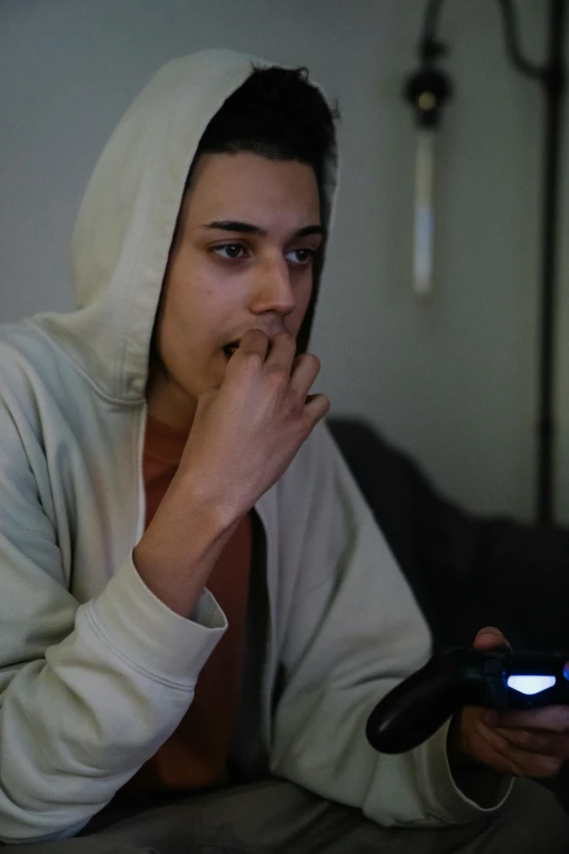 a person sitting on a couch holding a cell phone, reddit, wearing a hoody, smoking and bickering, 2020 video game screenshot, profile picture