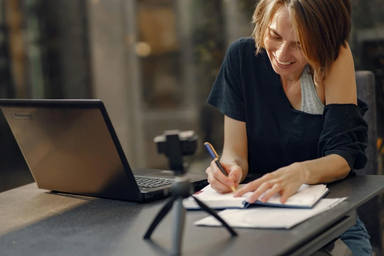 a woman sitting at a table in front of a laptop, a drawing, pexels contest winner, school curriculum expert, sarenrae, signing a bill, joshua cotter