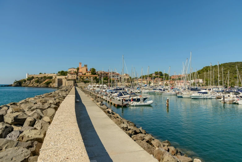 a large body of water filled with lots of boats, by Carlo Carrà, pexels contest winner, les nabis, red castle in background, sunny day time, thumbnail, small dock