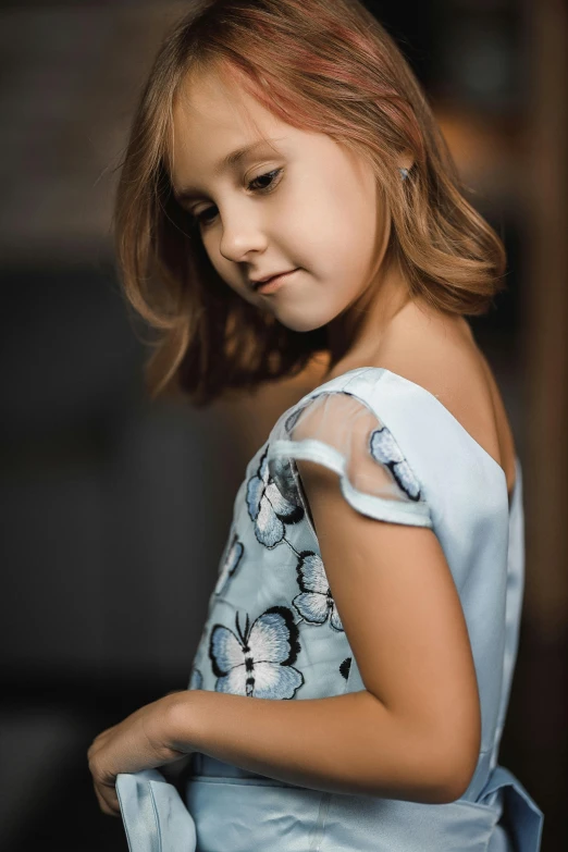 a little girl in a blue dress posing for a picture, inspired by Sophia Beale, trending on pexels, half-turned lady in evening gown, fashion shoot 8k, closeup of arms, 15081959 21121991 01012000 4k