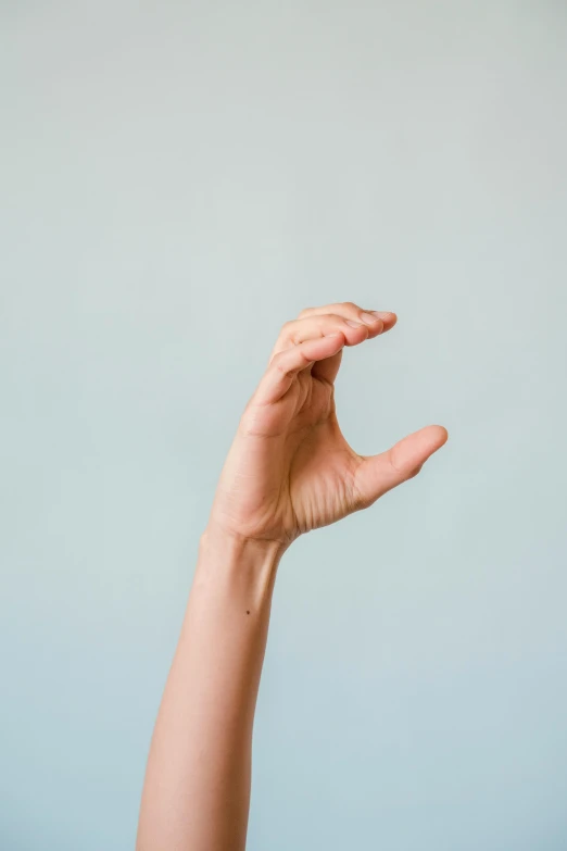 a person reaching up to catch a frisbee, by Carey Morris, pexels, minimalism, perfect hand anatomy, photo of a hand jewellery model, plain background, animation