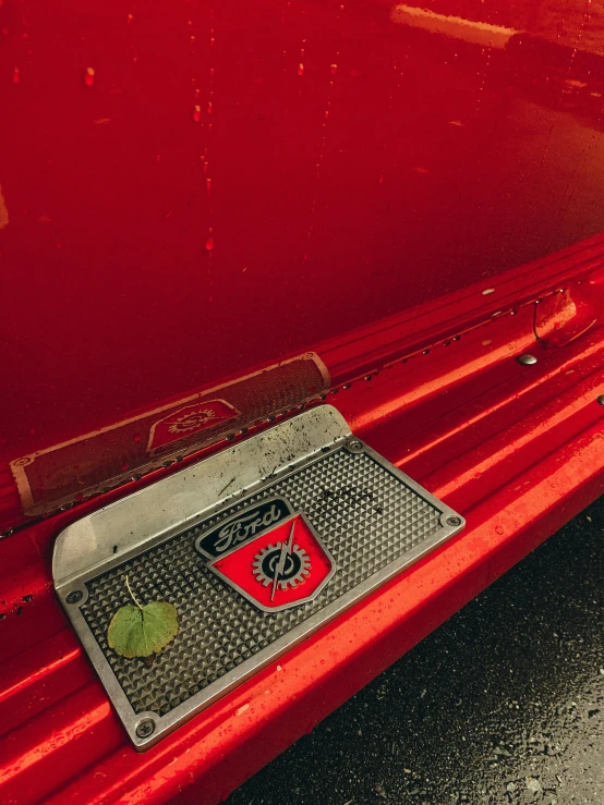 a close up of a license plate on a red car, a photo, cg society contest winner, floor grills, stunning details, photo taken in 2 0 2 0, detailed product image