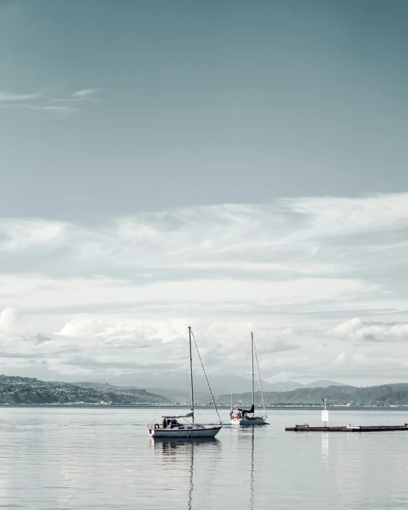 a number of boats in a body of water, inspired by Wilhelm Marstrand, pexels contest winner, romanticism, photo of zurich, white sea cloud, outdoor photo, white grey blue color palette