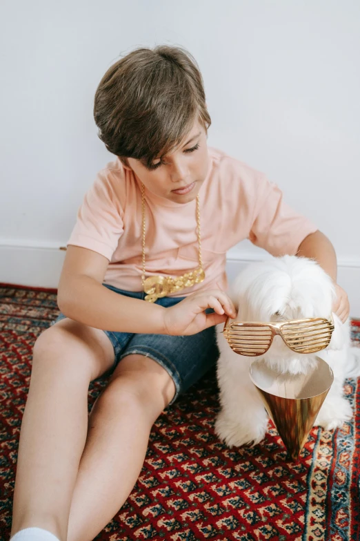 a little boy sitting on the floor with a teddy bear, an album cover, by Nicolette Macnamara, pop art, wearing gold glasses, with dogs, gold and luxury materials, wearing a designer top