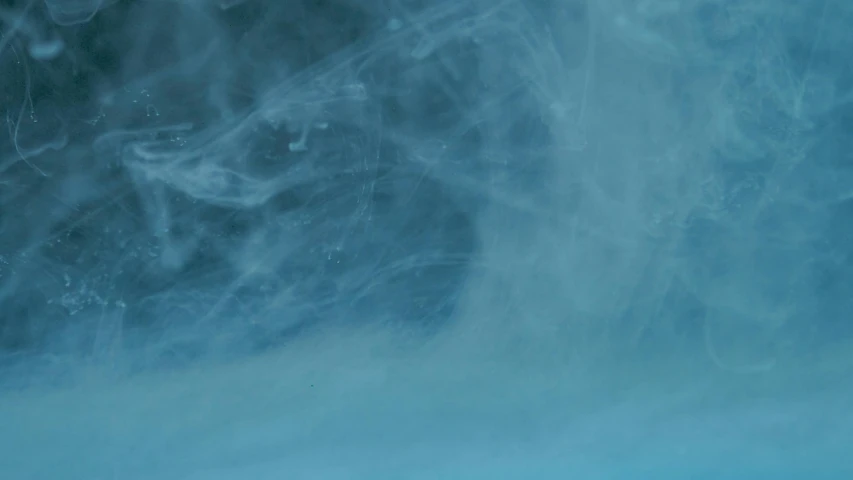 a pair of skis sitting on top of a snow covered slope, an album cover, inspired by Kim Keever, plasticien, whirling blue smoke, vfx film closeup, blue transparent jelly, hd footage