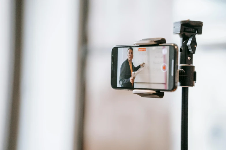 a close up of a cell phone on a tripod, trending on pexels, video art, photo of a classroom, actors, teaching