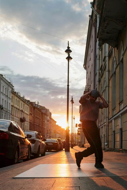 a man riding a skateboard down a sidewalk, a photo, by Sven Erixson, pexels contest winner, saint petersburg, summer sunset, raising between the buildings, lampposts