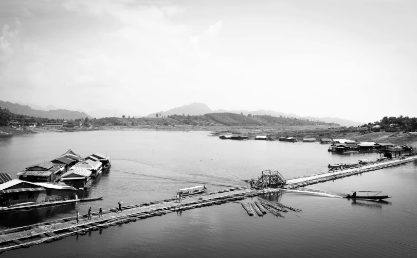 a black and white photo of a body of water, laos, docks, mixed art, illustration