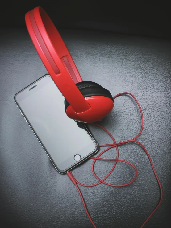 a pair of red headphones sitting on top of a cell phone, an album cover, pexels, multiple stories, 5k, modeled, color picture