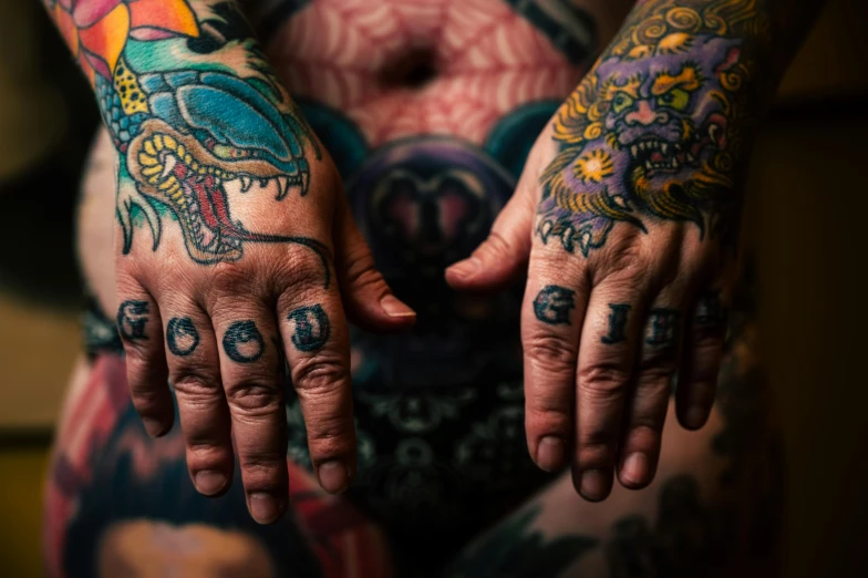 a close up of a person with tattoos on their hands, by Adam Marczyński, lynn skordal, various colors, tattoo parlor photo, psytrance and giger