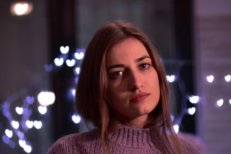 a close up of a person wearing a sweater, inspired by Elsa Bleda, pexels contest winner, photorealism, purple lights, handsome girl, soft lighting 8k, melanchonic rose soft light