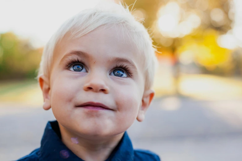 a close up of a child wearing a tie, blonde hair and blue eyes, bokeh + dof + 8k, looking upward, toddler