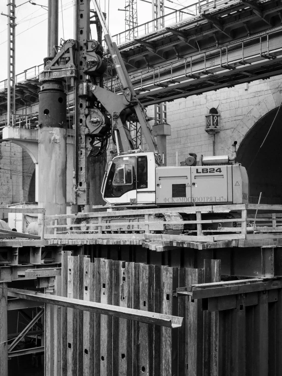 a black and white photo of a construction site, train in a tunnel, 2 0 0 4 photograph, ( mechanical ), big hammer