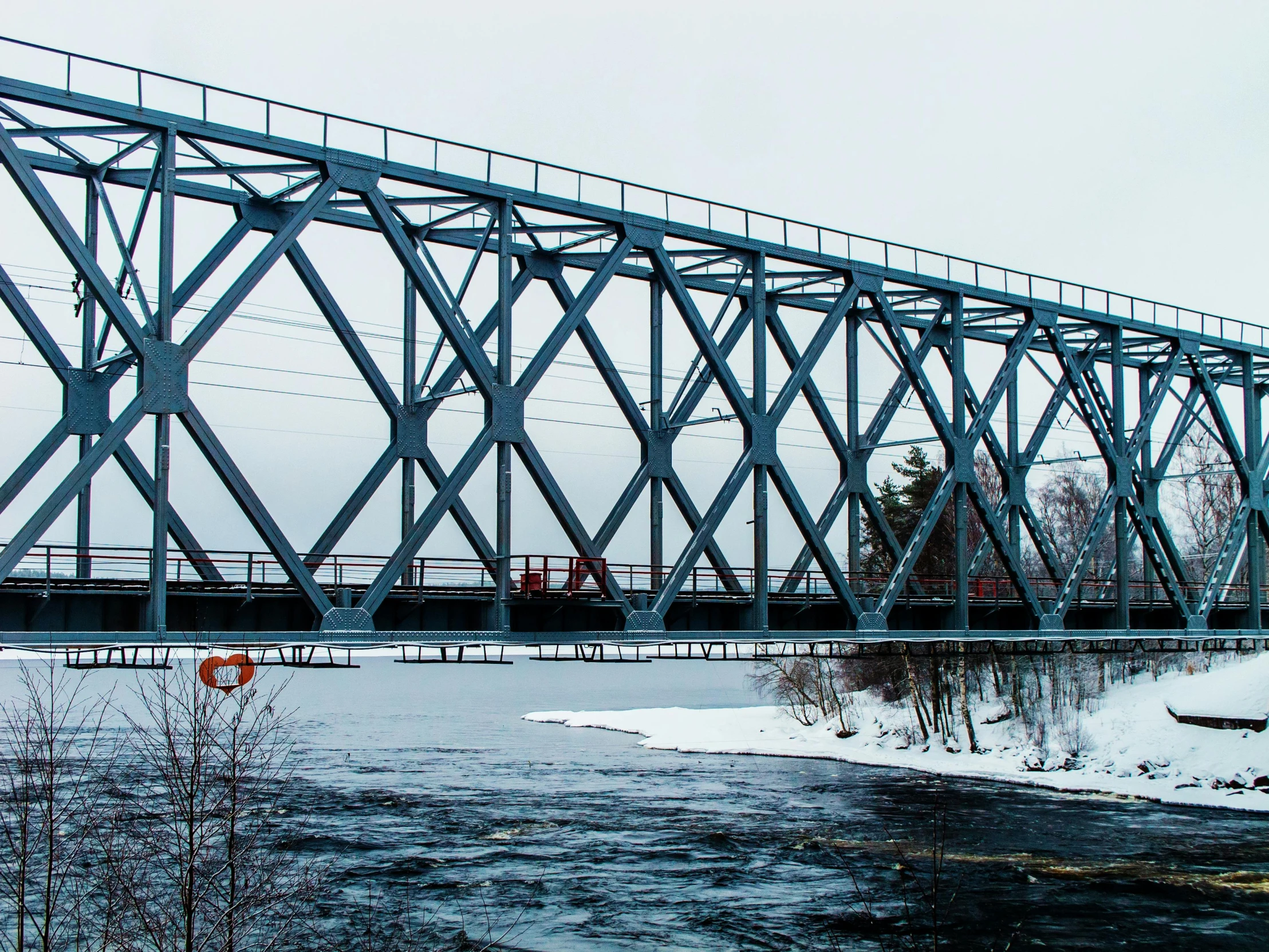 a train crossing a bridge over a river, by Veikko Törmänen, pexels contest winner, hurufiyya, truss building, cold hues, “ iron bark, hd footage