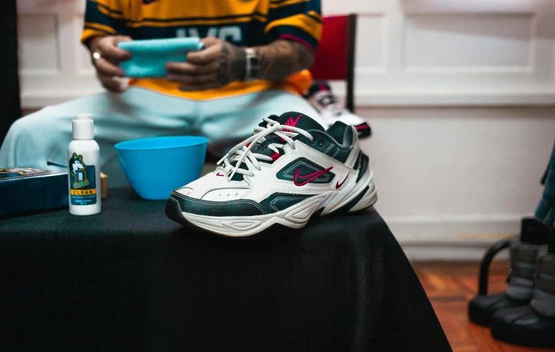 a pair of sneakers sitting on top of a table, inspired by Jordan Grimmer, trending on dribble, playboi carti, retro 9 0 s japanese, presenting wares, ultra wide shot