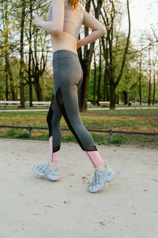 a woman running in a park with trees in the background, arabesque, leggings, thumbnail, detailed product image, mid shot photo