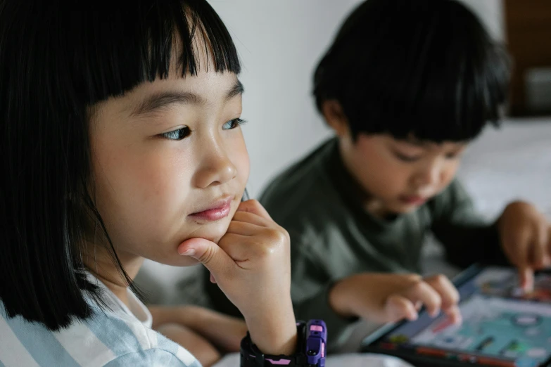 a couple of kids sitting next to each other on a bed, trending on pexels, ethnicity : japanese, high-tech devices, school class, avatar image