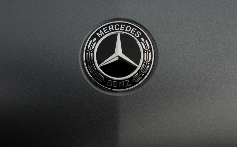 a close up of a mercedes emblem on a car, a hologram, pexels, in gunmetal grey, in 2 0 1 2, enamel, matte black paper