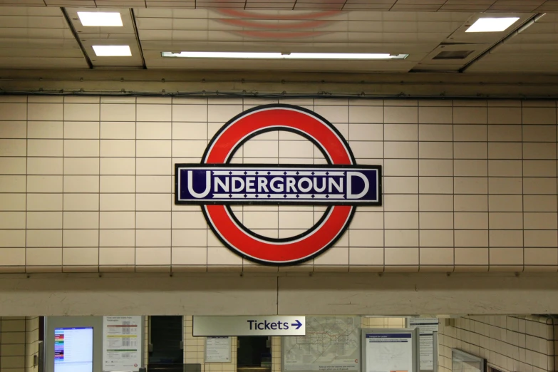 a subway station with a sign that says underground, by Rupert Shephard, unsplash, round-cropped, avatar image, fan favorite, london south bank