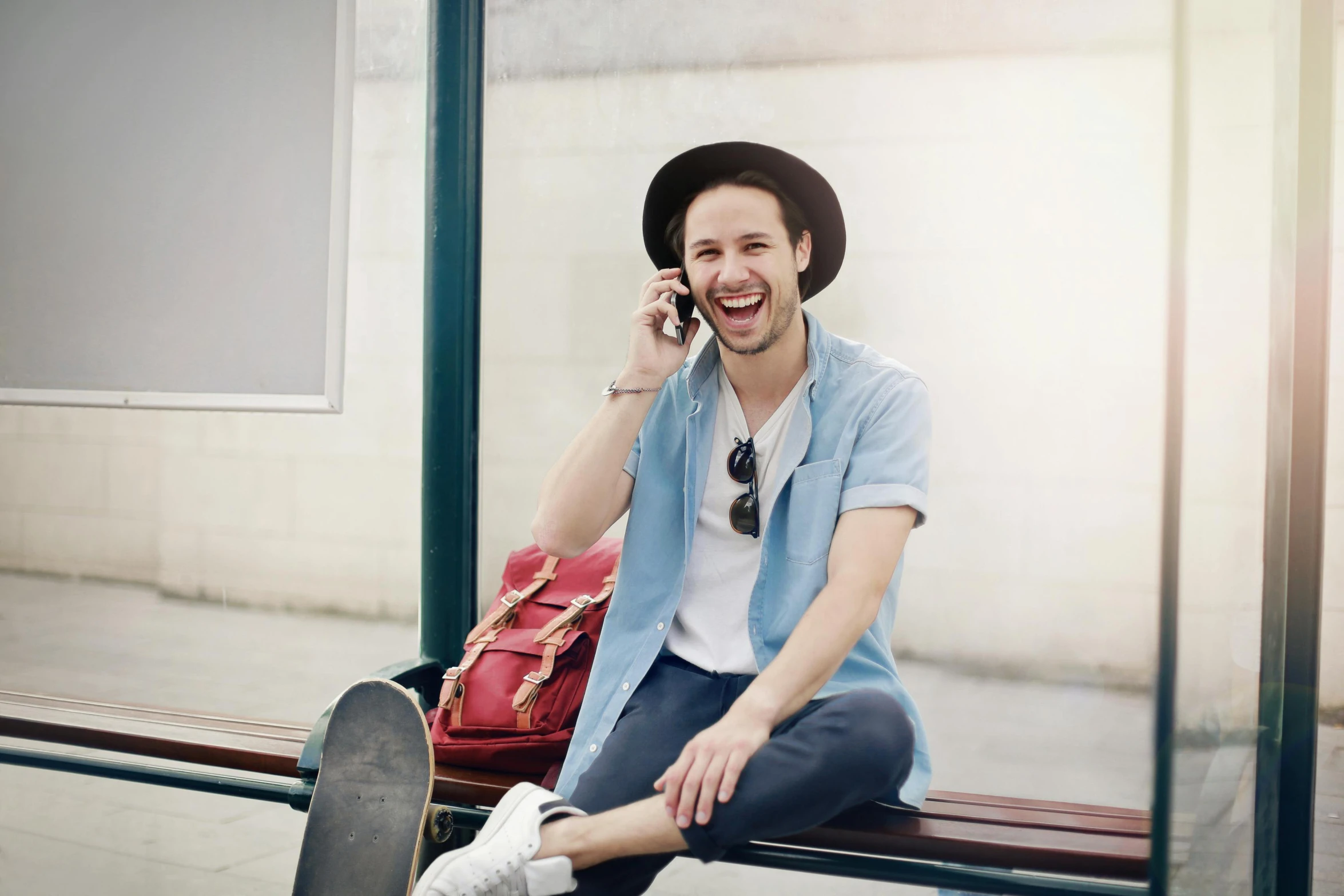 a man sitting on a bench talking on a cell phone, manically laughing, style of seb mckinnon, traveller, portrait image