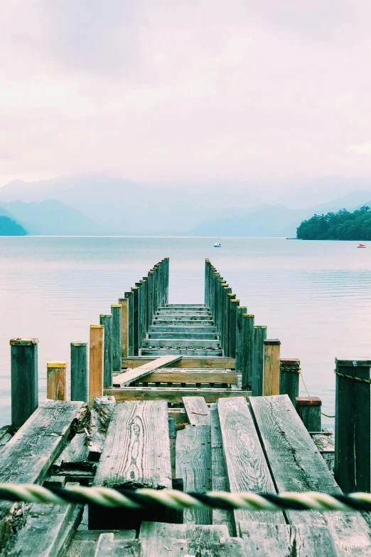 a wooden dock next to a body of water, pexels contest winner, vhs colour photography, patagonian, abel tasman, photographs