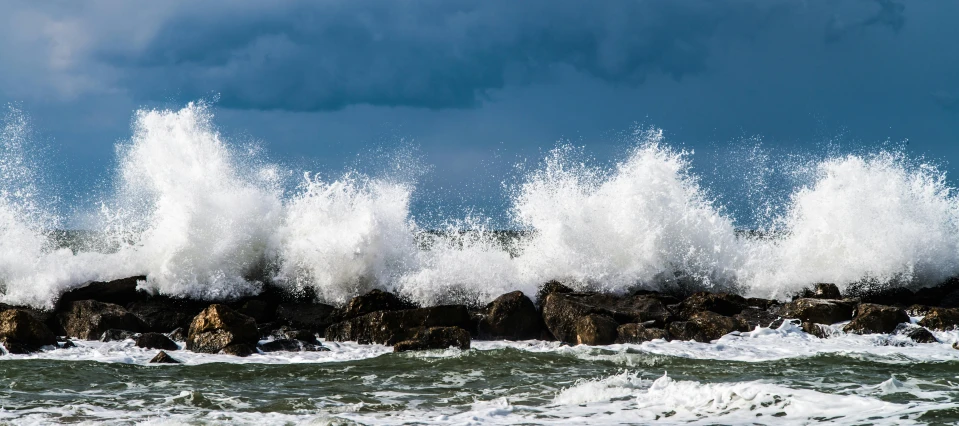 a man riding a surfboard on top of a wave, pexels contest winner, romanticism, waves crashing at rocks, paul barson, an angry, thumbnail