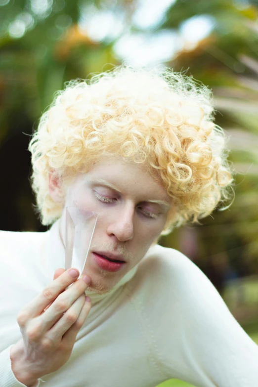 a close up of a person with blonde hair, an album cover, inspired by Cindy Sherman, featured on reddit, renaissance, intense albino, curls on top of his head, mime, lush paradise