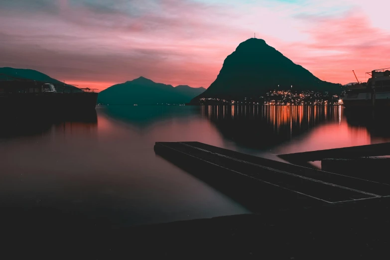 a body of water with a mountain in the background, by Sebastian Spreng, pexels contest winner, romanticism, redpink sunset, multiple stories, peaceful ambience, switzerland