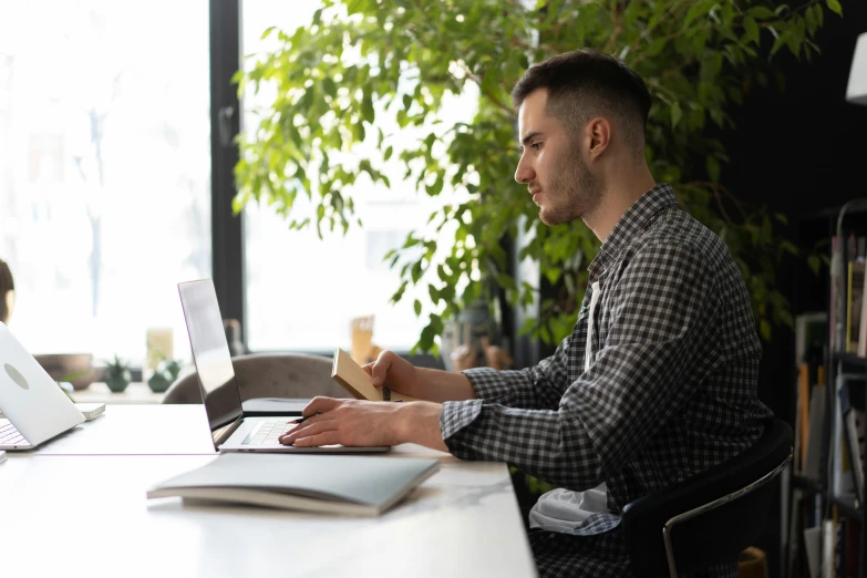 a man sitting at a desk using a laptop computer, pexels contest winner, lachlan bailey, wearing business casual dress, profile image, thumbnail