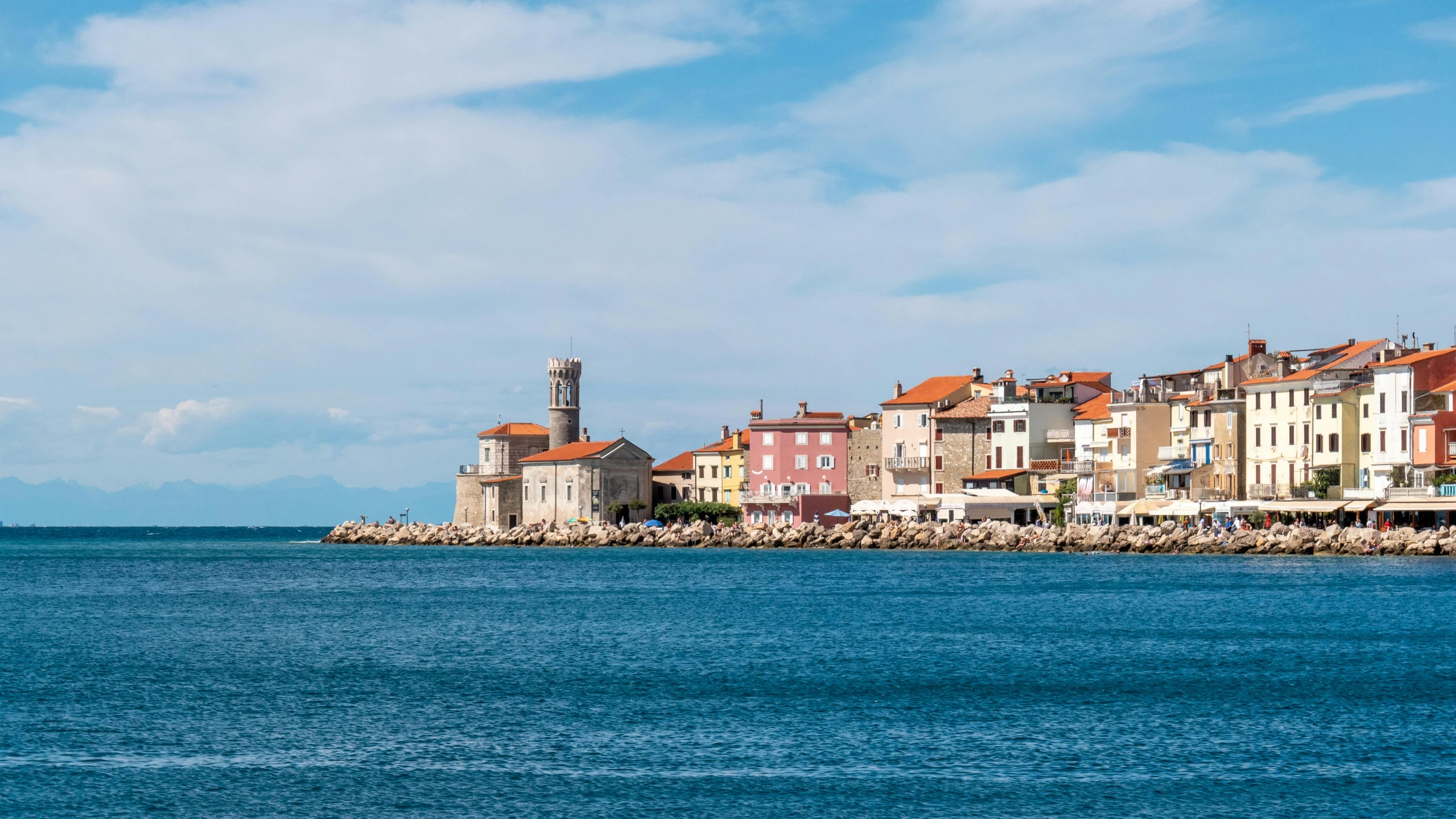 a group of buildings sitting on top of a body of water, a picture, croatian coastline, profile image, beachfront, exterior photo