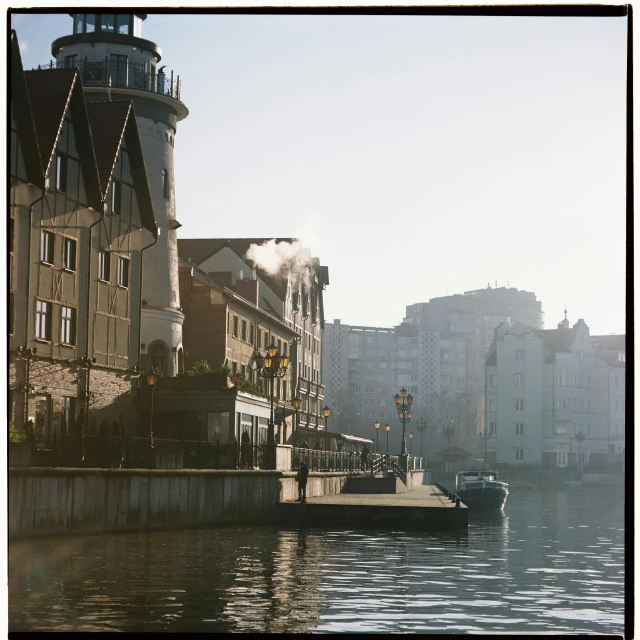 a boat that is sitting in the water, a polaroid photo, by Tobias Stimmer, pexels contest winner, danube school, chimneys on buildings, cinestill hasselblad 8 5 mm, light haze, canal