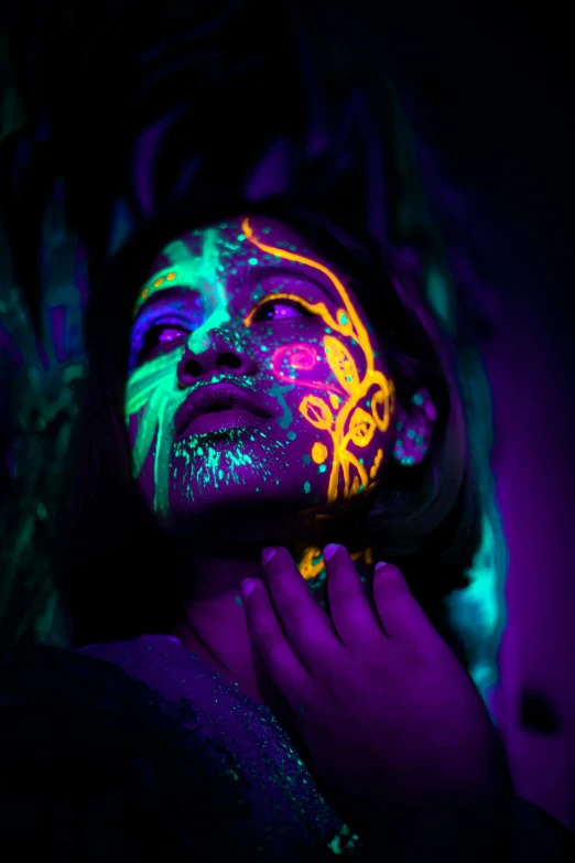 a woman with fluorescent paint on her face, a portrait, by Julia Pishtar, trending on pexels, psychedelic art, made of glowing oil, purple neon, detailed neon tattoos, colorful photograph