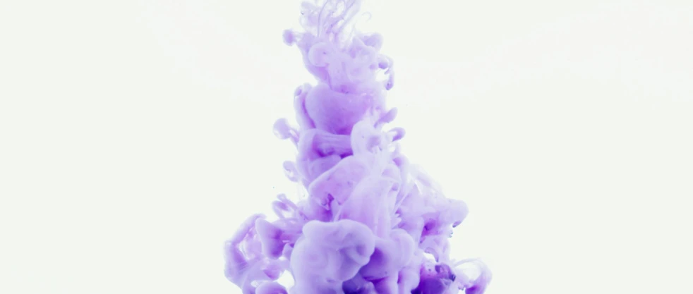 a close up of a purple substance in water, inspired by Yves Klein, pexels, made of cotton candy, videogame still, white and purple, family photo