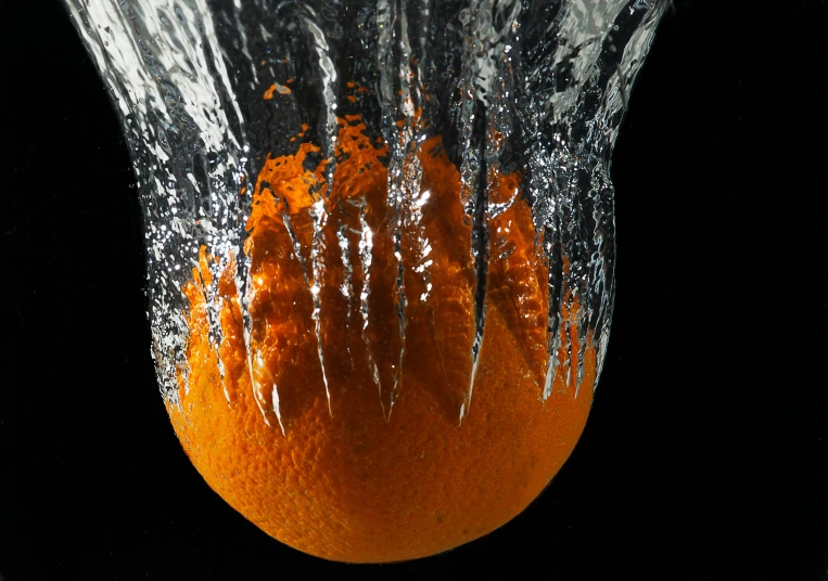 an orange being splashed with water on a black background, by Doug Ohlson, pexels, hyperrealism, ice sculpture, ball, ilustration, 2000s photo