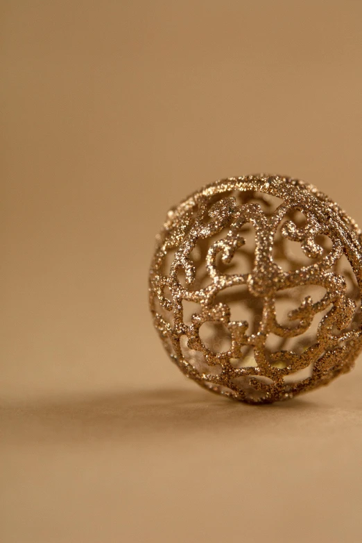 a close up of a ring on a table, a stipple, inspired by Gustav Doré, arabesque, glowing sphere, 3 d print, golden glistening, organic ornament