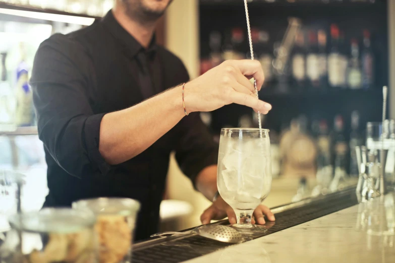 a man is making a drink at a bar, by Niko Henrichon, pexels, renaissance, fan favorite, crisp detail, plating, aussie baristas