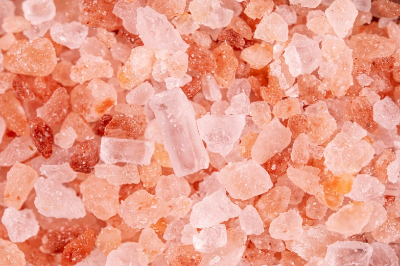 a pile of pink sugar sitting on top of a table, by Emma Andijewska, pexels, crystal cubism, light orange mist, soft red texture, geode, detailed product image