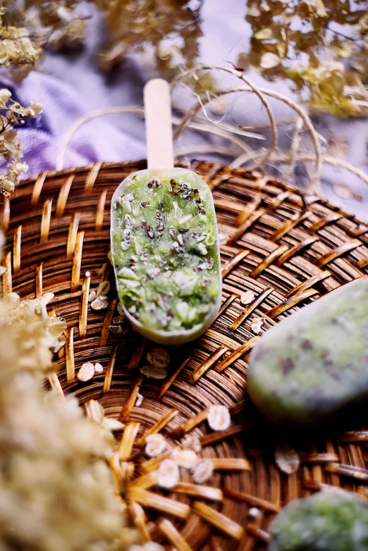 a couple of spoons sitting on top of a wicker basket, floating crystals, luscious with sesame seeds, algae, handcrafted