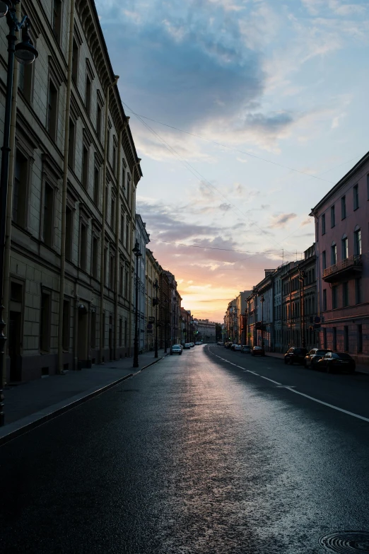 a street lined with tall buildings under a cloudy sky, by Anna Haifisch, pexels contest winner, renaissance, saint petersburg, summer sunset, empty streetscapes, after rain