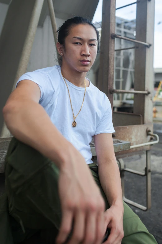 a man wearing a white shirt and green pants, inspired by Ryan Yee, unsplash, wearing a gold chain, around 1 9 years old, silo, asian features